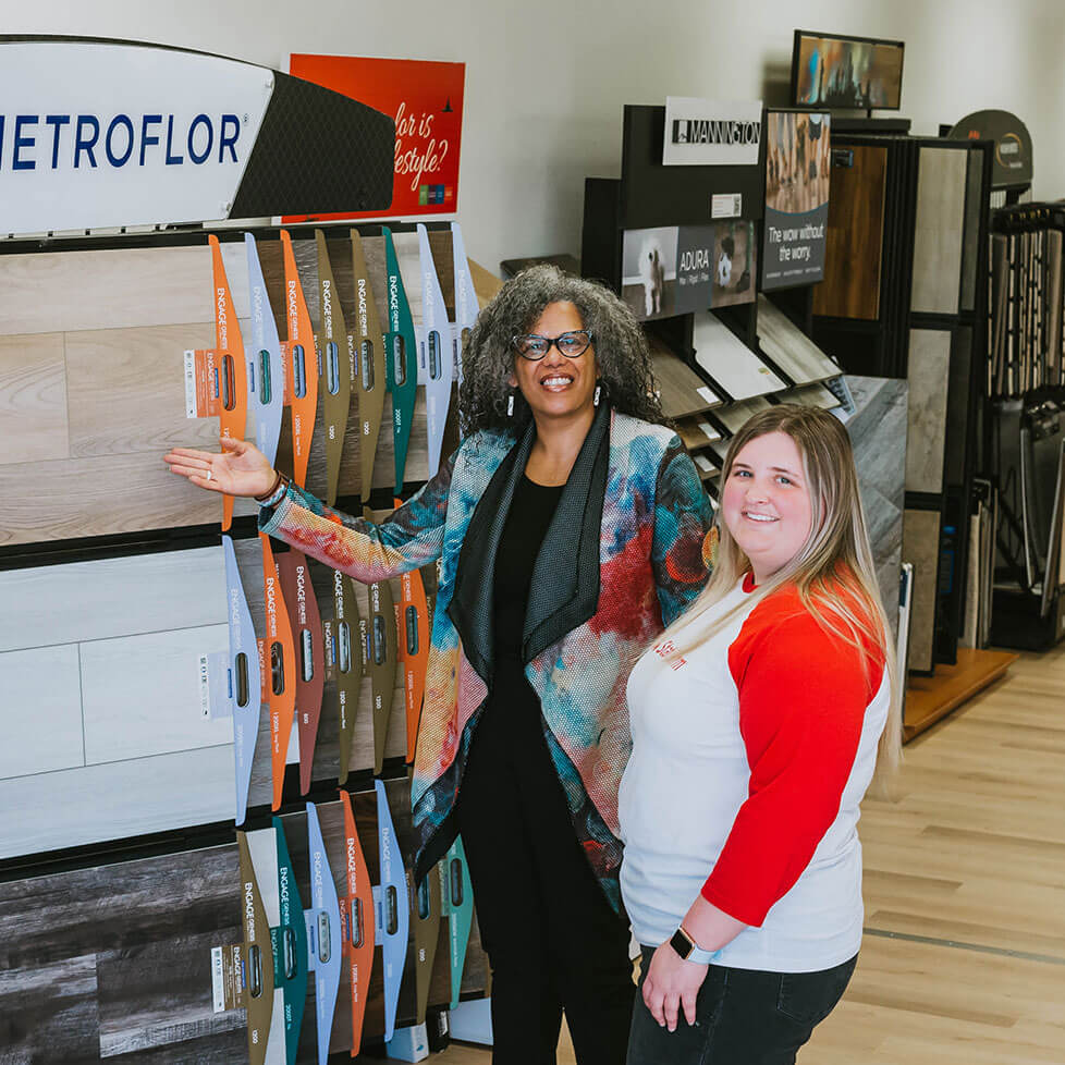 Roz helps a client select flooring at the store.